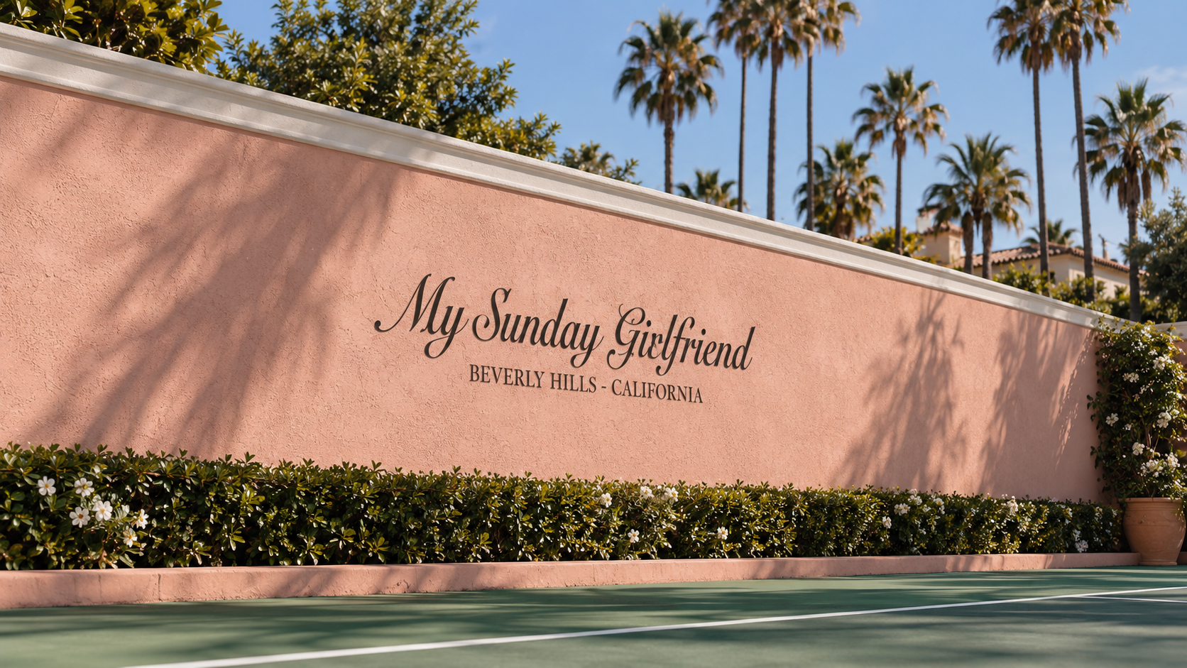 Signature pink My Sunday Girlfriend wall with palm trees at the Beverly Hills tennis court
