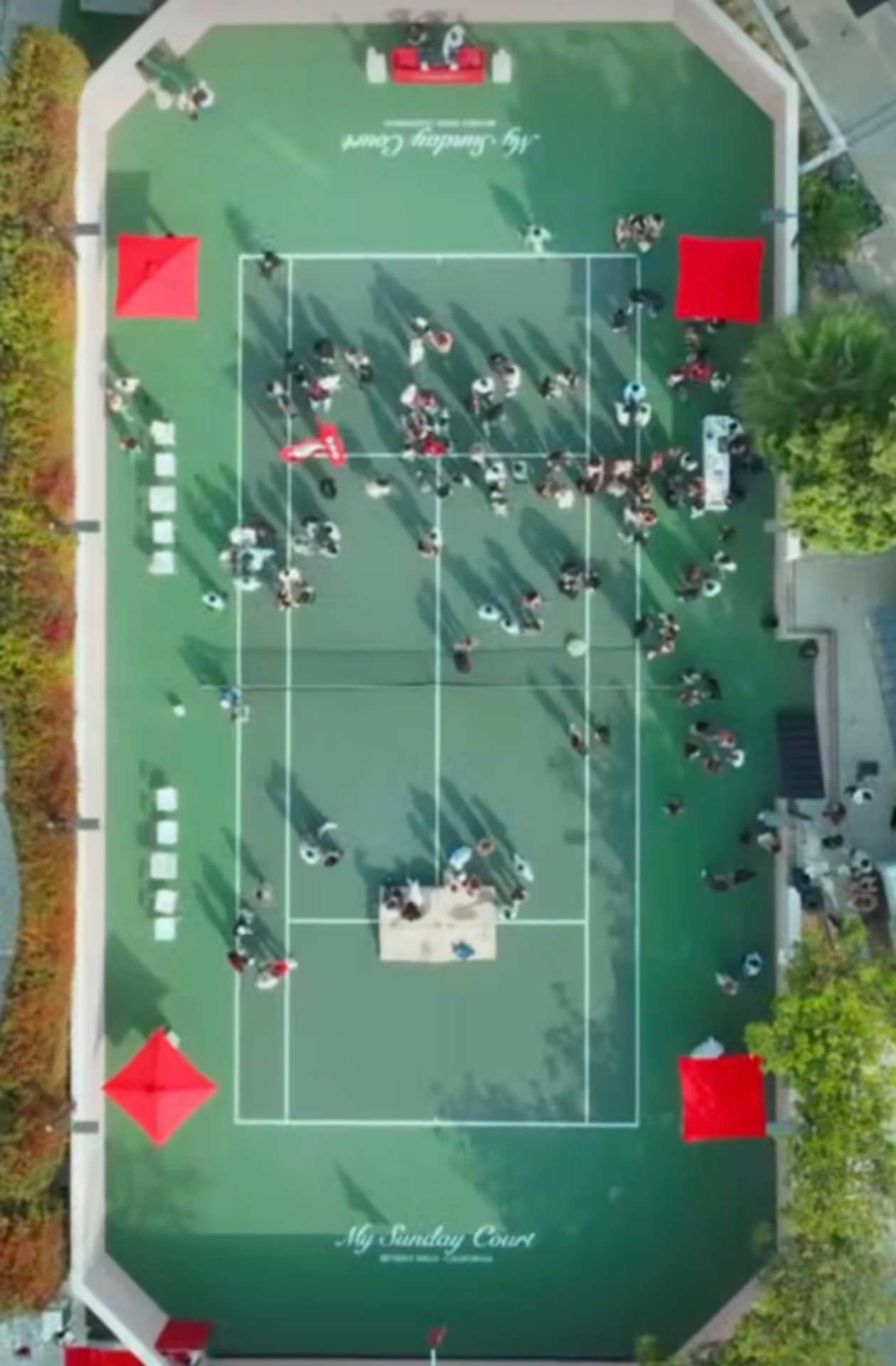 Aerial view of the private tennis court and event guests